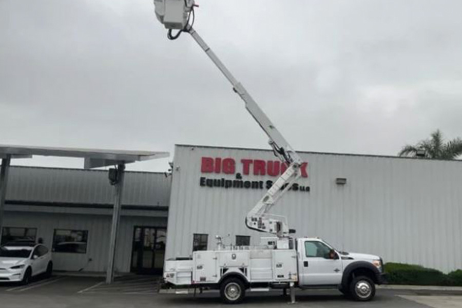 A white bucket truck from the inventory of Big Trucks & Equipment Sales